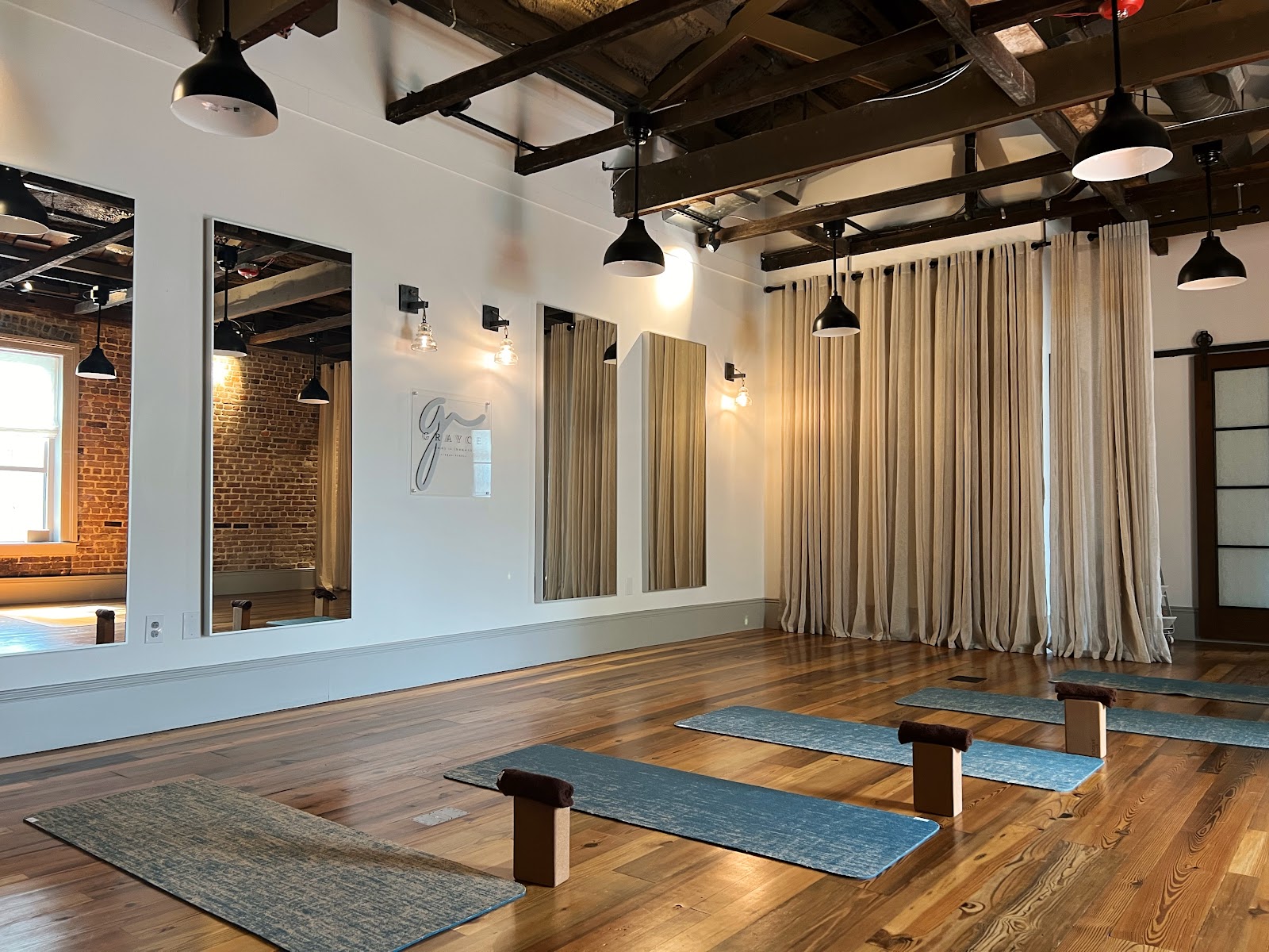 Soft natural light across the practice room at Grayce Yoga